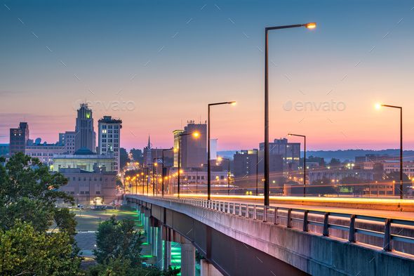 the city skyline at night with street lights and buildings in the background - stock photo - images