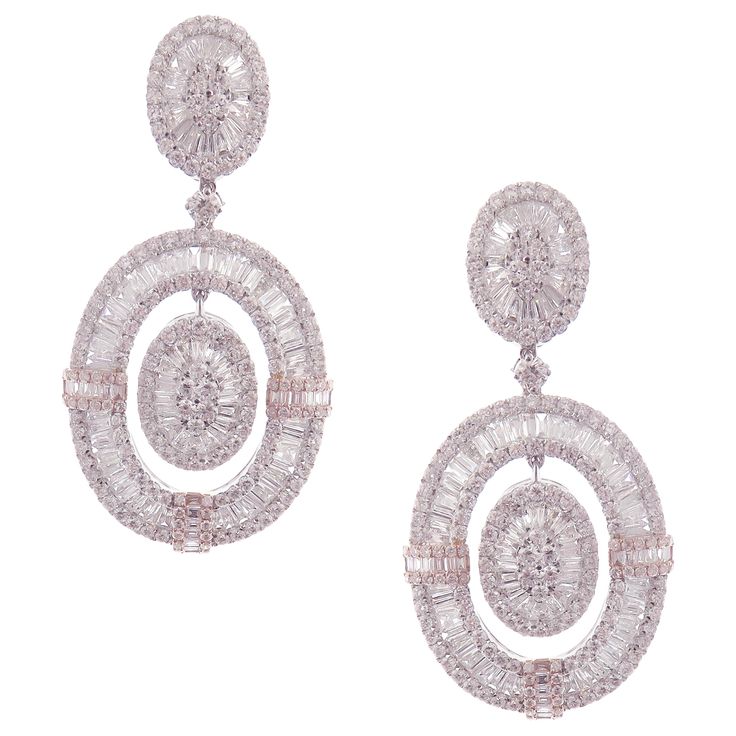 These modern oval baguette earrings are crafted in 18-karat white gold, weighing approximately 14.65 total carats of SI-V Quality white diamond. French Clip backing. Beautiful rose gold accent. Our Ballroom Collection feature earrings for those with bold/classy aesthetics and elegant tastes. 346 Round Diamonds = 7.84 ct 235 Baguette Diamonds = 6.81 ct Baguette Earrings, Baguette Earring, French Clip, Rose Gold Accents, Diamond Dangle Earrings, American Modern, Circle Diamond, White Gold Earrings, Women Diamond