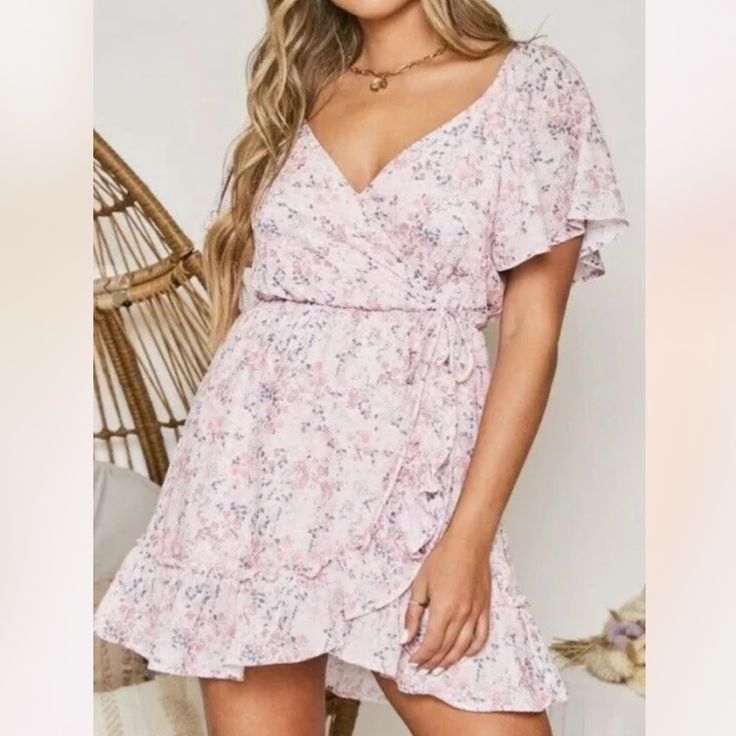 Brand : Peach Love California Size : S Bust 38” Hip 42” Length 34” M Bust 40” Hip 44” Length 34” L Bust 42” Hip 46” Length 34” Color : Pink Material : Polyester Condition : New Flutter Sleeve Mini Dress Floral Print Flirty V-neck Floral Dress For The Beach, Cute V-neck Mini Dress For Garden Party, Peach V-neck Dress For Brunch, Feminine Floral V-neck Dress For Day Out, Peach V-neck Spring Dress, Pink Floral V-neck Dress For Brunch, Flirty Mini Dress With Surplice Neckline For Summer, Feminine Summer Mini Dress With Surplice Neckline, Feminine Mini Dress With Surplice Neckline For Summer