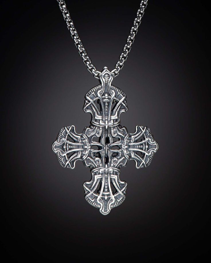 The Tranquility is a sculpted cross infused with pattern and texture inspired by medieval armor. Crafted from solid sterling silver, Tranquility hangs on a sterling silver rounded box chain at 2.6mm diameter with a lobster clasp. Materials Sterling Silver Features & Specs Pendant dimensions: 47 x 34 x 7mm Silver Gothic Box Chain Jewelry, Gothic Sterling Silver Jewelry With Polished Finish, Gothic Sterling Silver Jewelry, Luxury Sterling Silver Cross Necklace, Silver Cross Necklace With Large Pendant, Gothic Cross Pendant Necklace With Engraving, Gothic Sterling Silver Jewelry With Intricate Design, Silver Cross Jewelry Symbolic Style, Gothic Silver Box Chain Necklace