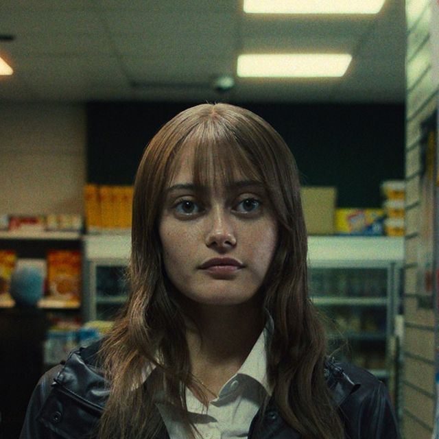 a woman standing in front of a book shelf