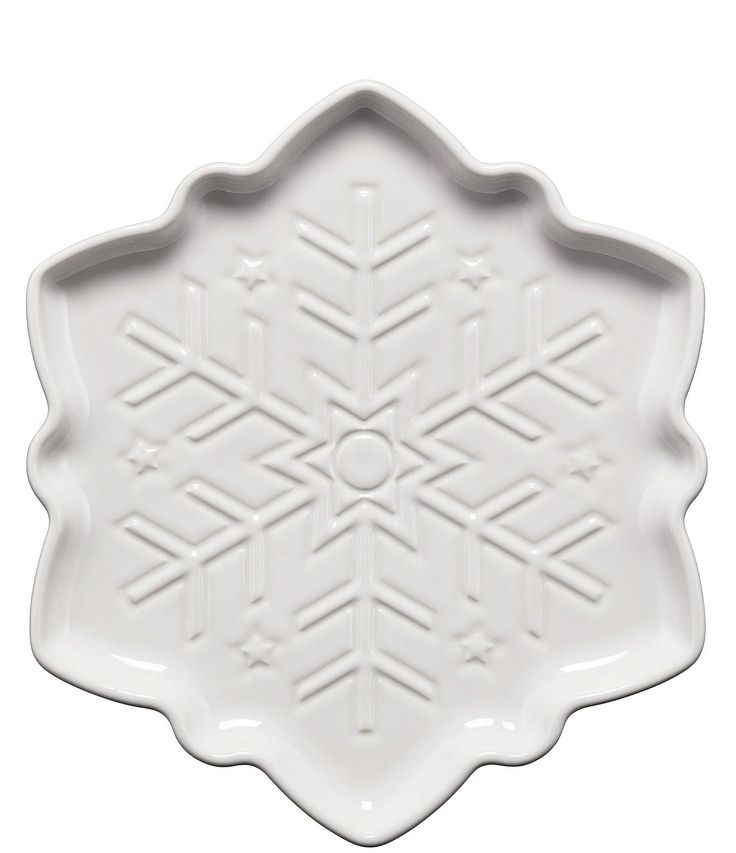 a white platter with an intricate design on the front and side, in the shape of a snowflake