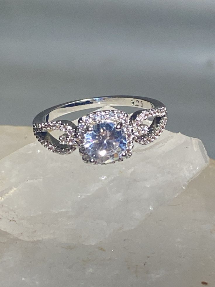 "Cocktail ring sparkling CZ's evening dress sterling silver women girls Size 9.75 Weight. 3.5g Length 5/16\" Width 5/16\" Thinnest part of band 1/8\" Free Shipping & Free Postal Insurance Delivered in a Gift Box If you do not want the ring polished and want to leave the natural patina please let me know at the time of purchase as I do polish rings before I ship rings out. Thanks Free First Class shipping and postal insurance is included. If you want to upgrade to priority kindly pay an addit Dazzling Formal Crystal Ring With Halo Design, Glamorous Brilliant Cut Diamond Ring For Party, Glamorous Brilliant Cut Diamond Party Ring, Elegant Sparkling Cluster Ring For Anniversary, Elegant Sparkling Crystal Promise Ring, Glamorous Sparkling Diamond Ring, Glamorous Sparkling Round Diamond Ring, Sparkling Crystal Promise Ring In Fine Jewelry Style, Silver Amethyst Ring For Formal Occasions