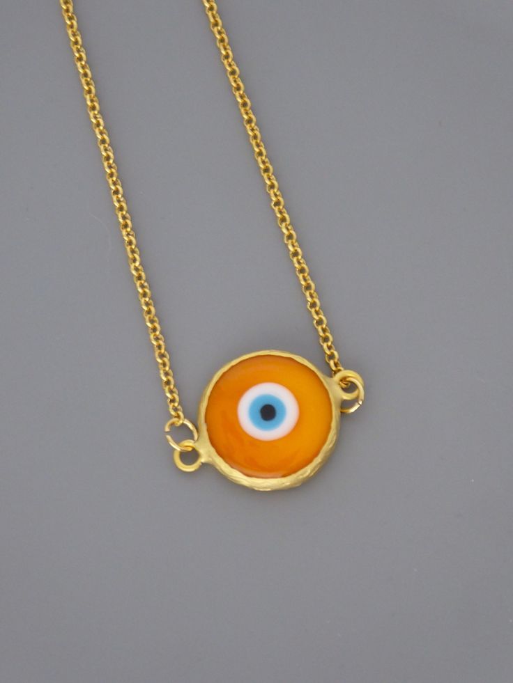 "Evil Eye Necklace - Orange Necklace - Gold Necklace - Good Luck Necklace - Chloe's Vintage Jewelry - handmade jewelry This is a very cool Evil Eye handmade glass pendant. A bright orange and blue glass evil eye in a gold plated bezel. It hangs on a gold plated chain. Chloe says, \"Wear it and feel fabulous!\" The pendant is 1\" long. You can choose the length of chain you would like at checkout. Thanks for visiting Chloe's" Handmade Symbolic Round Jewelry, Symbolic Handmade Circular Jewelry, Spiritual Round Orange Jewelry, Orange Spiritual Jewelry, Orange Amulet Necklace For Gift, Orange Amulet Style Necklace As A Gift, Yellow Spiritual Round Jewelry, Adjustable Symbolic Handmade Necklaces, Yellow Pendant Necklace Nickel Free