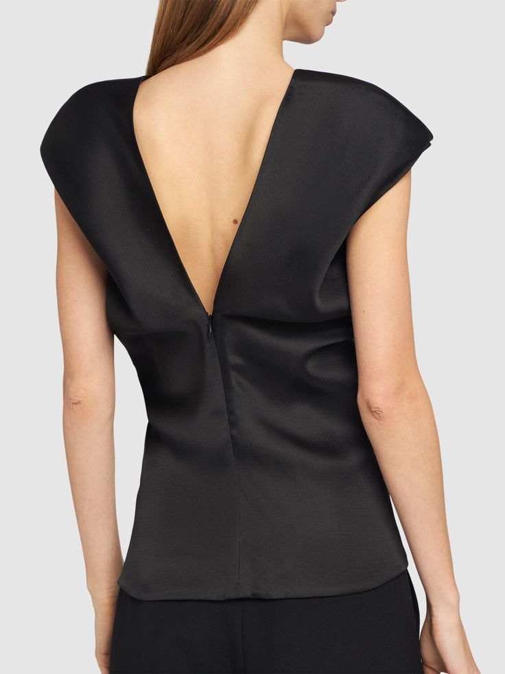 Concealed back zip closure. Model is wearing a size2 Elegant Fitted Top With Padded Shoulders, Elegant Fitted Tops With Padded Shoulders, Elegant Structured Evening Tops, Elegant Cowl Back Top For Evening, Elegant Structured Tops For Night Out, Chic Evening Tops With Back Zipper, Elegant Party Tops With Back Zipper, Structured Fitted Blouse For Formal Occasions, Elegant Fitted Top With Cowl Back