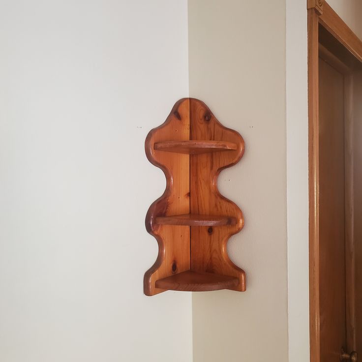 a wooden shelf mounted to the side of a wall