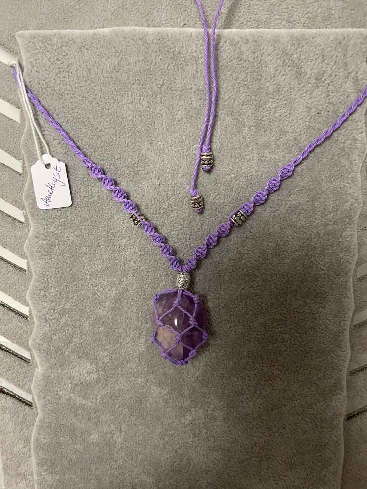 Here I offer you a lovingly knotted necklace in macramé technique (adjustable in length) with a beautiful healing stone Bordered is a light amethyst, color of the stone is purple and the size is about 3 x 2.5 cm (widest point), the color of the necklace is purple with silver-colored beads I assign them to the forehead chakra and the strengthening of our 3rd eye The light amethyst has the following qualities: Spiritual level: Peace, spirituality, clarification and meditation Mental / emotional le Spiritual Purple Macrame Jewelry, Adjustable Amethyst Crystal Necklace As Gift, Adjustable Amethyst Crystal Necklace For Gift, Bohemian Purple Jewelry With Adjustable Cord, Adjustable Amethyst Crystal Necklace, Adjustable Amethyst Crystals With Natural Stones, Bohemian Lavender Crystal Gemstone Necklace, Bohemian Lavender Gemstone Crystal Necklace, Adjustable Bohemian Lavender Crystal Necklace