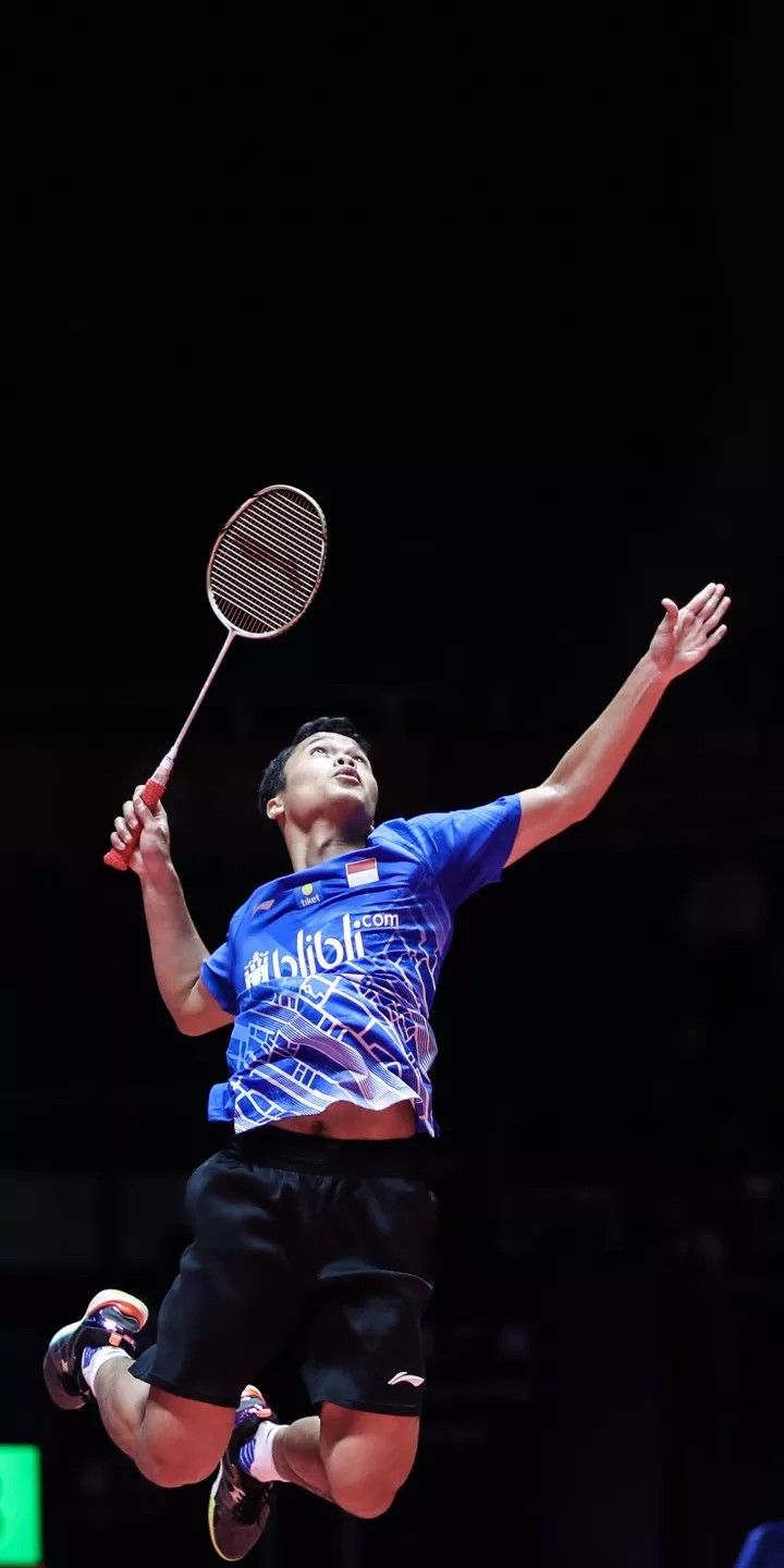 a man jumping in the air with a tennis racquet on his hand and head