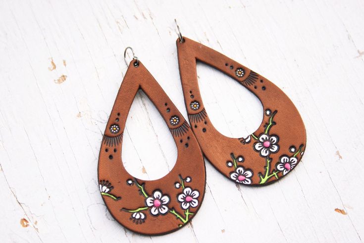 "✿ This is a Made to Order listing; please allow time for its creation. Just view the Shipping & returns section for view our current production turnaround time! :-) Cherry Blossom and Daisy teardrop earrings - Handmade Leather Earrings - Totally light as a feather :) This is a made to order listing, while your earrings will be made as closely as possible to resemble the originals, due to their handmade nature, please allow for slight variations in the placement and color of your special pair. C Bohemian Teardrop Hand Tooled Earrings, Hand Tooled Teardrop Bohemian Earrings, Bohemian Hand Tooled Teardrop Earrings, Handmade Brown Bohemian Teardrop Earrings, Bohemian Teardrop Earrings For Everyday, Hand Painted Bohemian Earrings For Everyday, Bohemian Brown Teardrop Earrings Gift, Bohemian Brown Teardrop Earrings For Gift, Handmade Hippie Jewelry For Spring