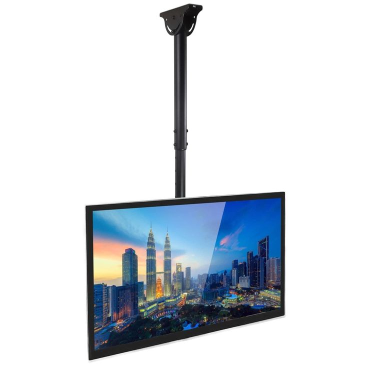 a flat screen tv mounted to the side of a pole in front of a cityscape