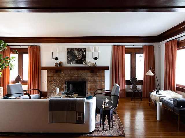 a living room filled with furniture and a fire place in the middle of a room