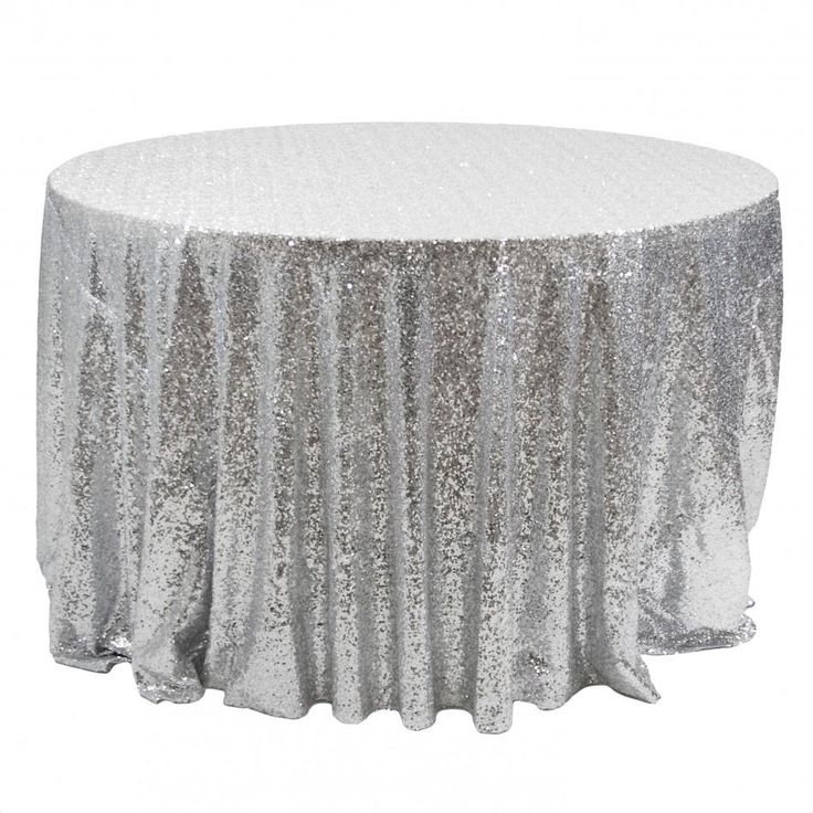 a round table covered in silver sequins and with a white cloth on top