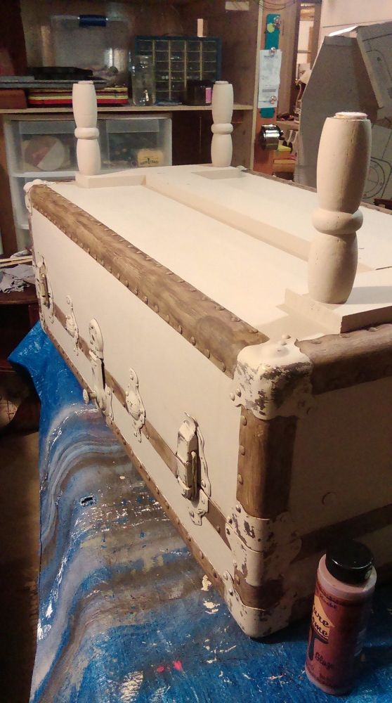 an old trunk sitting on top of a blue tarp