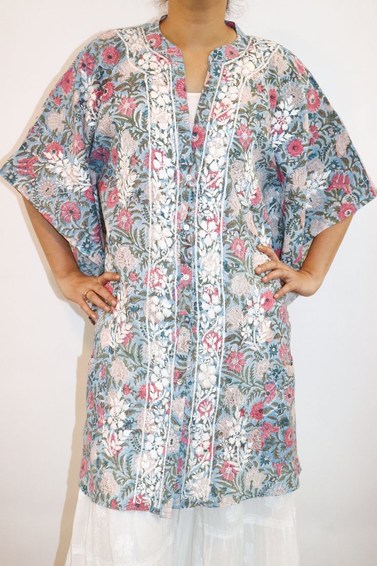 Introducing our Block Printed Cotton Kaftan, a wearable canvas of artistry and comfort. This kaftan effortlessly blends tradition and contemporary flair, featuring stunning Chikankari embroidery that adds a touch of elegance to the intricate block print. The front open button-down style not only ensures ease but also makes a chic statement, allowing you to flaunt your style with grace. Designed for both fashion and functionality, this kaftan boasts two open pockets in the front, offering a perfect blend of convenience and trendiness. Crafted from breathable cotton, it feels as light as air against your skin, making it an ideal choice for any occasion. Embrace the fusion of style and craftsmanship as you step out in this uniquely adorned block printed kaftan, ready to turn heads and make a Kurta With Printed Motifs And Kimono Sleeves, Traditional Kurta With Floral Print And Kimono Sleeves, Festive Floral Print Kimono, Traditional Tunic With Kimono Sleeves, Bohemian Relaxed Fit Kimono For Daywear, Bohemian Cotton Kimono With Batik Print, Traditional Floral Print Kaftan, Traditional Cotton Tunic Kimono, Cotton Tunic Kimono For Spring