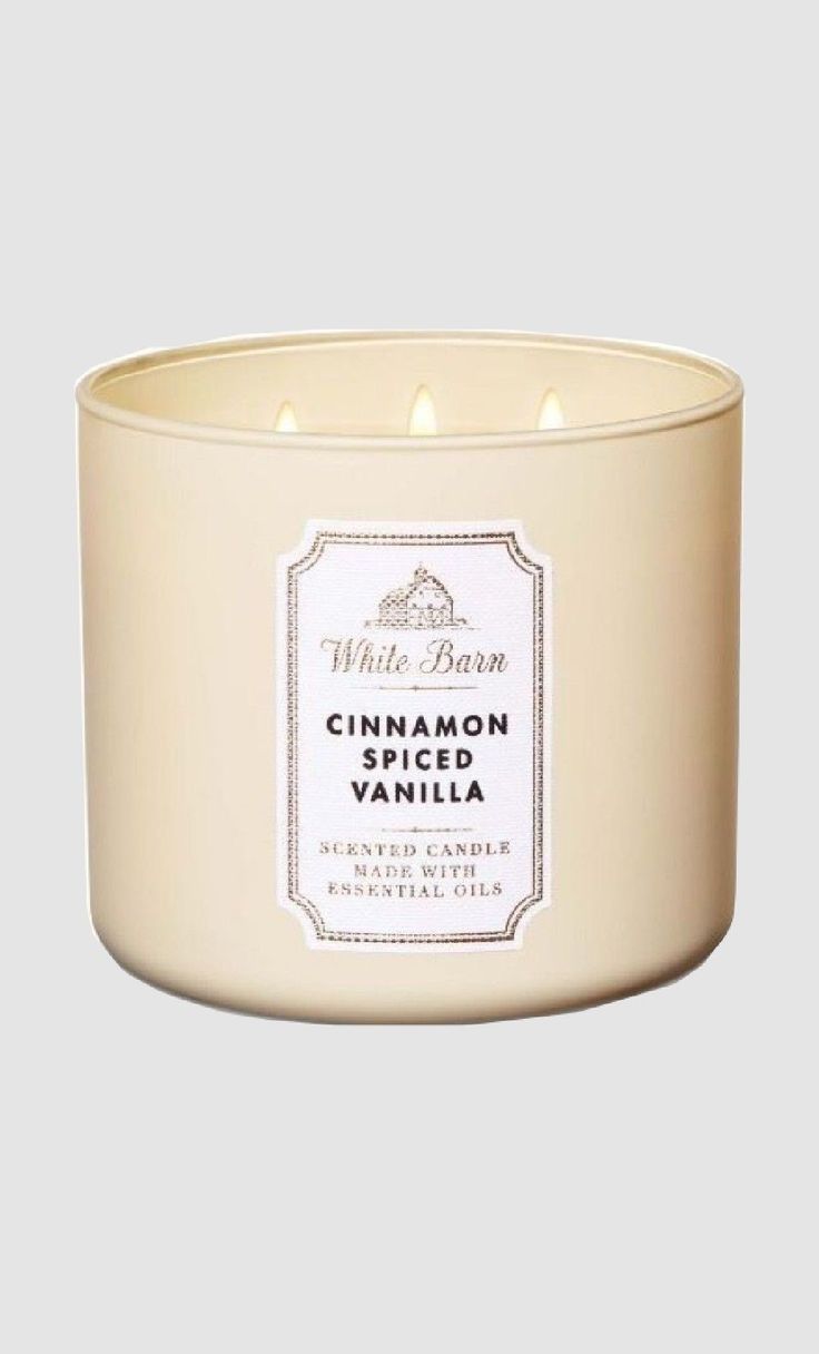 a white candle with cinnamon spiced vanilla inside