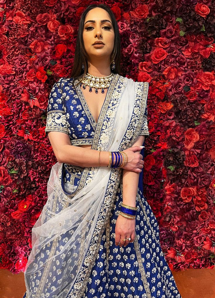 Subtle hues of whimsy blend with floral embroideries in this Royal Blue lehenga. The mehreen lehenga, embroidered with beautiful floral motifs and golden embroidery work, looks every bit of the royal self! Color - Fabric & Work Style -- Silk lehenga: Rich embroidery, floral embroidery work.- Silk embroidered blouse.- Net dupatta. Details -- Assured quality.- Wash care instruction: Dry clean only.- Slight variation in color is possible due to digital photography. Designer Kundan Lehenga With Intricate Embroidery, Bollywood Style Festive Floral Embroidered Choli, Dola Silk Lehenga With Intricate Embroidery For Reception, Reception Lehenga With Intricate Embroidery In Dola Silk, Reception Dola Silk Lehenga With Intricate Embroidery, Elegant Lehenga With Intricate Embroidery For Navratri, Elegant Designer Choli With Floral Embroidery, Elegant Dola Silk Chandbali Lehenga, Navratri Lehenga With Intricate Kundan Embroidery