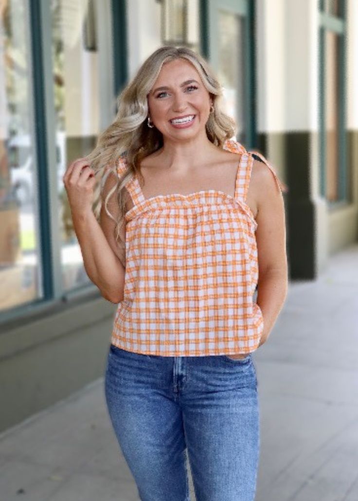 Get checked out in the Hannah Gingham Top! This stylish piece comes with tie straps and a square neckline that's perfect for sunny days. Oh, and the gingham print? A timeless classic. So, grab your sunnies and take on the day in style! For longer fit, size up. Everyday Plaid Summer Tops, Plaid Tops For Everyday Summer Wear, Summer Gingham Tops With Tie Straps, Trendy Summer Tops For Picnic, Trendy Plaid Tops For Summer, Spring Gingham Top With Square Neck, Spring Gingham Square Neck Top, Gingham Square Neck Top For Spring, Everyday Gingham Tops For Spring