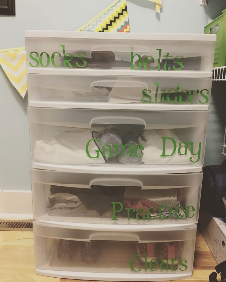 plastic storage containers with labels on them that say socks, shorts, gowns, and diapers