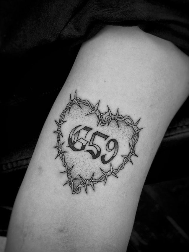 a black and white photo of a tattoo with the number 35 on it's arm