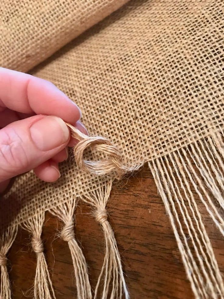 someone is stitching together some burlap