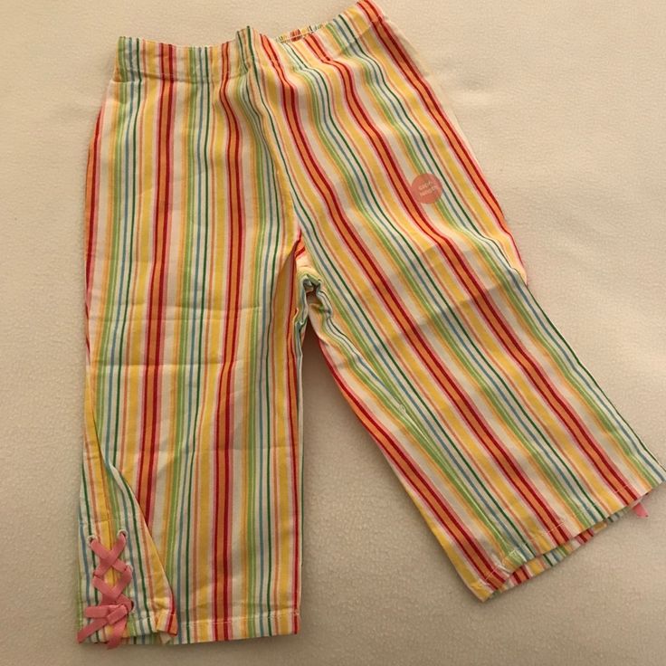 Vertical Striped Capri Pants In Bright Rainbow Fruit Colors - Red, Orange, Yellow, Green, Blue And Pink. Has Pretty Pink Lace Ties On Bottoms. From The Gymboree Tutti Fruity Line. Cute Yellow Bottoms For Playwear, Yellow Cotton Playtime Bottoms, Multicolor Bottoms For Playtime In Spring, Playful Yellow Cotton Pants, Yellow Bottoms For Spring Playtime, Yellow Cotton Playwear Bottoms, Cute Yellow Bottoms For Playtime, Yellow Bottoms For Playtime In Spring, Yellow Cotton Bottoms For Playwear