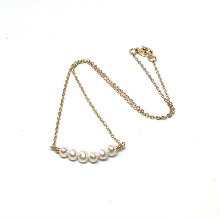 This attractive and dainty pearl necklace is made with six small 3mm pearls and 14K gold filled chain with a 14K gold filled lobster clasp. This minimalist pearl necklace is so versatile that it can be worn with the most casual to most formal of outfits. The necklace is available in four necklace lengths. Please choose the length you need from the drop-down menu. The necklace will arrive in an attractive gift box. Minimalist Everyday 14k Gold Filled Pearl Necklace, Minimalist 14k Gold-filled Pearl Necklace For Everyday, Minimalist Everyday Pearl Necklace With 14k Gold Filled, Everyday Minimalist 14k Gold-filled Pearl Necklace, Everyday Minimalist Pearl Necklace In 14k Gold, Everyday Minimalist Pearl Necklace With Tiny Beads, Simple Gold Pearl Chain Necklace, Gold Pearl Necklace With Simple Chain, Simple Gold Pearl Necklace With Delicate Chain