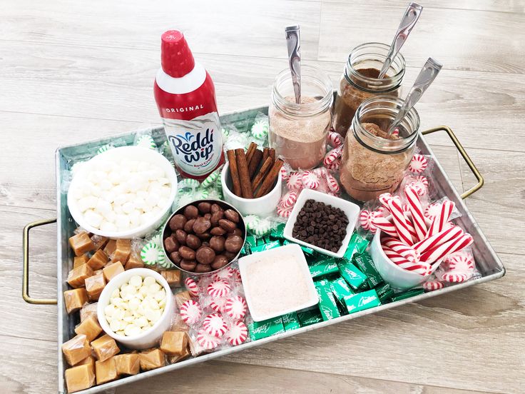 a tray filled with candy, marshmallows and other treats