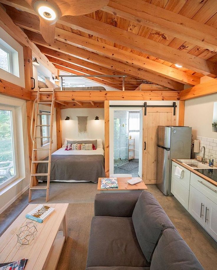 an instagramted photo of a living room and kitchen in a tiny house on pinterest