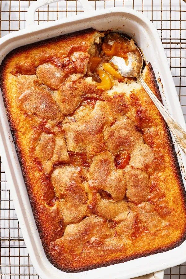 a casserole dish filled with fruit and topped with ice cream on a cooling rack