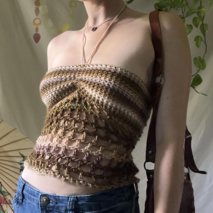 a woman with short hair wearing a brown top and holding an open parasol in her hand