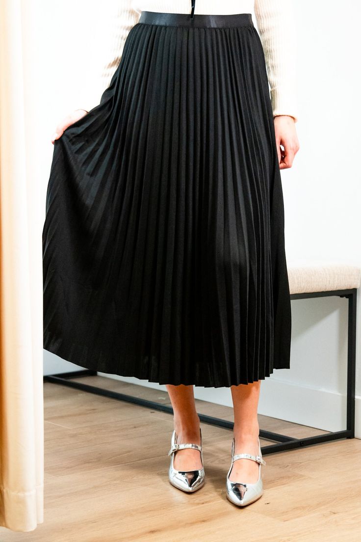 Get ready for an evening out with our Victoria skirt. Featuring a luxurious black accordion pleated design, this midi length skirt exudes elegance and refinement. Elevate any outfit with this chic and sophisticated piece. Elastic satin waistband Mary Grace is wearing XS/S with a 32B bust, 25” waist and 36” hip. 95% Polyester, 5% Spandex Hand wash cold and line dry Flared Accordion Pleated Skirt For Party, Flared Pleated Skirt With Accordion Pleats For Party, Flowy Party Maxi Skirt With Pleated Hem, Midi Skirt With Folds For Party, Pleated Midi Skirt For Party, Party Midi Skirt With Folds, Relaxed Pleated Maxi Skirt For Night Out, Chic Full Maxi Skirt For Night Out, Party Midi Skirt With Pleated Hem