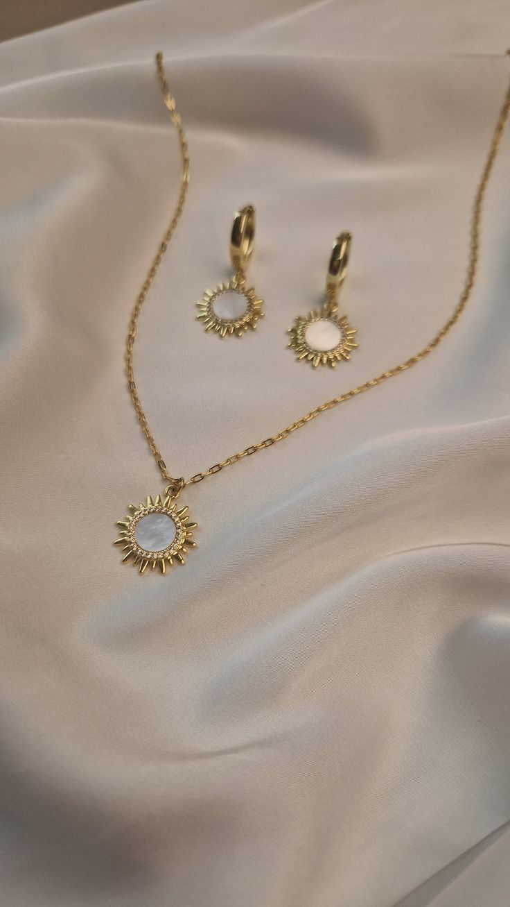 Elevate your wedding day style with our exquisite boho jewelry set. Featuring a stunning celestial pendant chain necklace and elegant gold plated sun earrings, this collection is designed for the modern bride who loves bohemian charm. Each piece is crafted with meticulous attention to detail, blending celestial motifs with timeless elegance to create jewelry that is both unique and breathtaking. MATERIAL - 18 K gold plated brass, natural mother of pearl SIZE - standard size of the necklace - 45 Elegant Moon Charm Necklace For Wedding, Rose Gold Plated Jewelry With Moon Charm, Delicate Gold Plated Jewelry, Dainty Plated Wedding Jewelry, Celestial Metal Jewelry, Dainty Plated Dangle Jewelry, Elegant Light Gold Wedding Jewelry, Elegant Adjustable Jewelry With Moon Charm, Delicate Moon Charm Necklace For Wedding