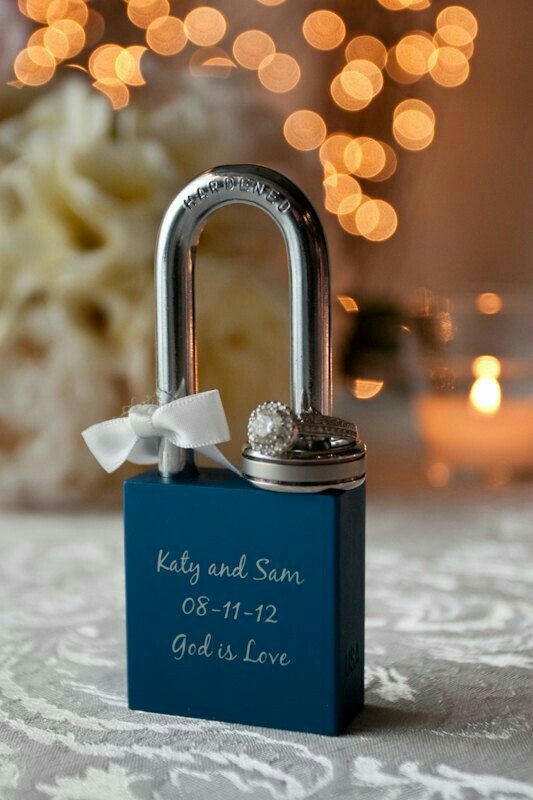 a blue padlock with a white bow on it sitting on top of a table