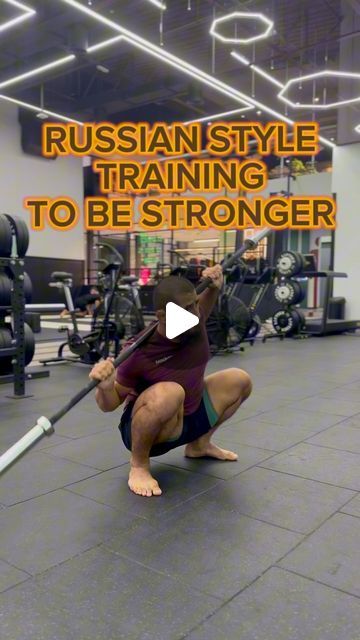 a man squatting down with a barbell in his hand and the words russian style training to be stronger above him