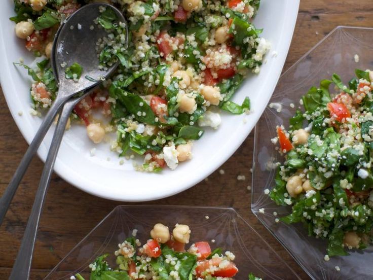 two plates filled with salad on top of a wooden table