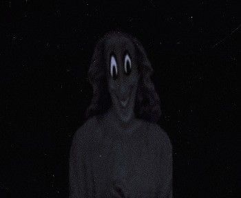 a creepy looking person standing in the dark with his hands on his hips and eyes wide open