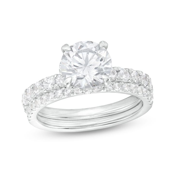 Symbolize your love with the classic design of this stunning certified round lab-created diamond bridal set in 14K white gold. Fashioned in 14K white gold The engagement ring showcases a 2 ct. certified round lab-created diamond boasting a color rank of I and clarity of Si2. Lab-created diamonds line the shank and sparkle along a hidden halo design beneath the center stone. On your wedding day, present the coordinating lab-created diamond band. Includes certification card This bridal set dazzles Dazzling Bridal Sets With Brilliant Cut Diamonds, Round Cut Diamond Bridal Set With Accents, Moissanite White Gold Bridal Set For Promise Ring, White Gold Moissanite Bridal Set For Promise Ring, Dazzling Diamond Bridal Set With Center Stone, Lab Grown Diamond Wedding Ring With Vvs Clarity, Classic Bridal Sets With Diamond Center Stone, Diamond White Bridal Sets With Prong Setting, Round Lab Grown Diamond Ring With Vvs Clarity