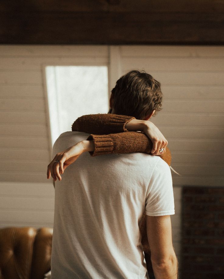 a man is holding his arm around another man's neck