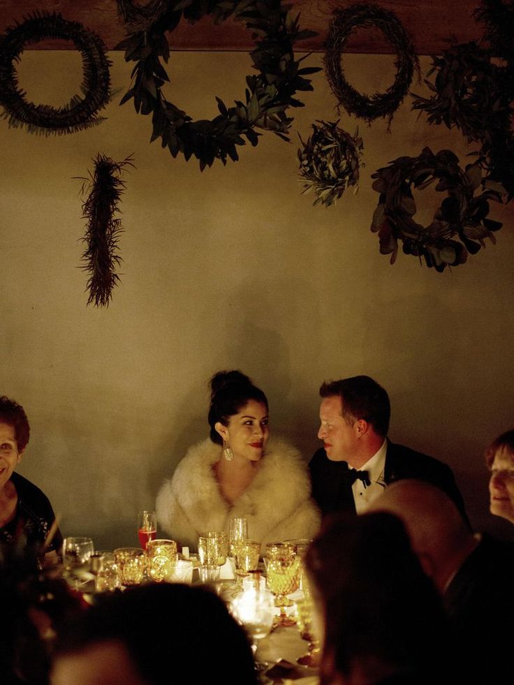 a group of people sitting around a dinner table