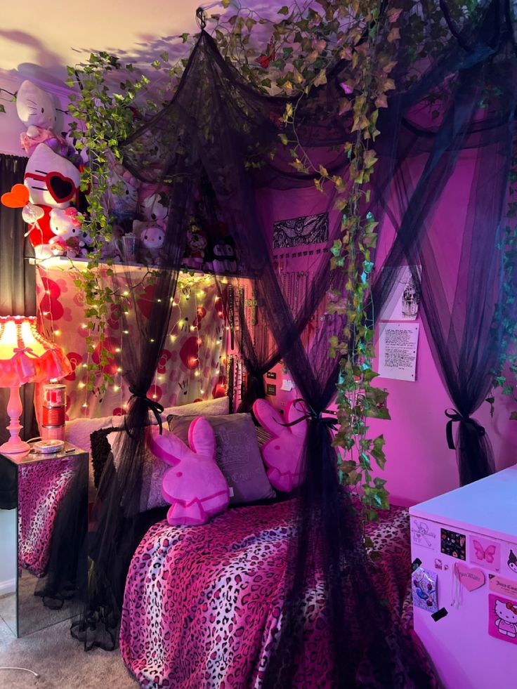 a bedroom decorated in pink and black with stuffed animals on the bed, hanging from the ceiling