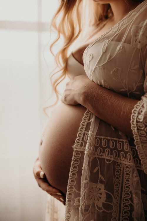 the pregnant woman is holding her stomach in front of an instagramtion screen shot