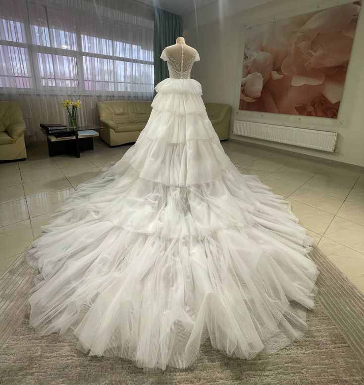 a white wedding dress on display in a room