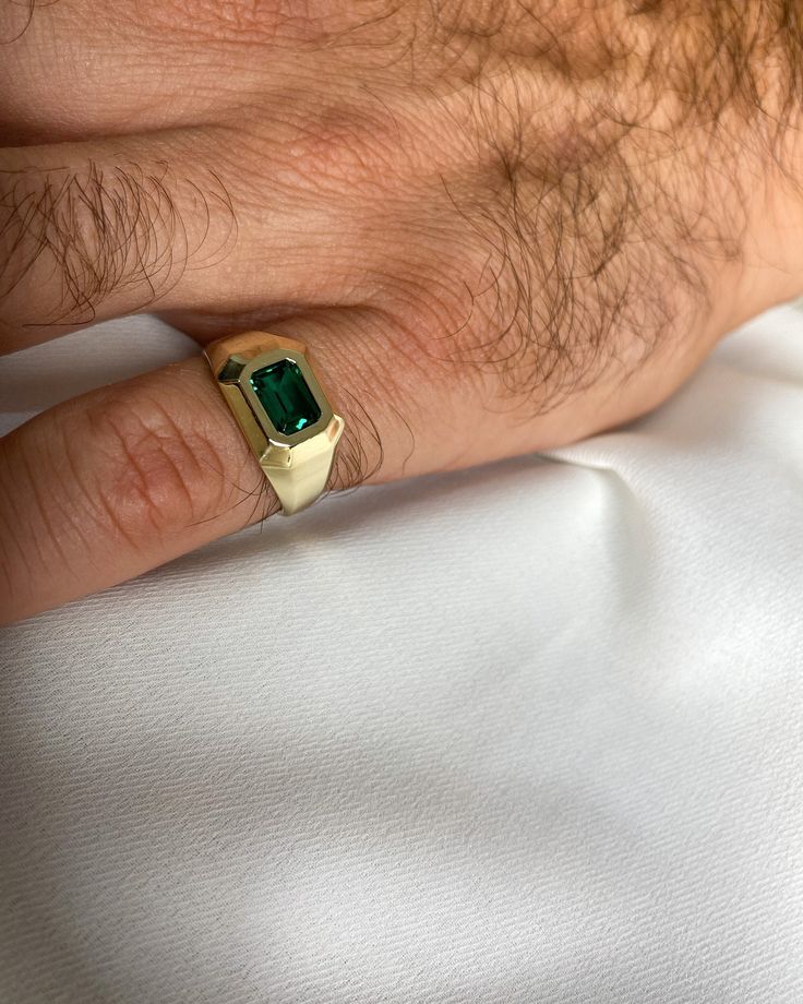 "Men emerald signet / pinky ring made from 14K yellow gold. A Modern geometric ring with a faceted structure set with a gorgeous Chatham emerald. Personalized signet ring, free engraving can be added by choice. Available also in other gold colors such as white gold or rose gold and also in 18K gold - please see all options and quoting in the drop down menu above. **Please note that personalized items can not be returned or exchanged. Thank you for your understanding.  Ring description: * Top wid Emerald Signet Ring Men, Classic Green Open Signet Ring, 14k Gold Open Signet Ring With Gemstone, 14k Gold Green Ring With Polished Finish, Fine Jewelry Green Signet Ring With 17 Jewels, Gold Emerald Signet Ring Gift, Green Signet Ring With Polished Finish For Promise, Men Emerald Ring, 14k Gold Emerald Ring With 17 Jewels