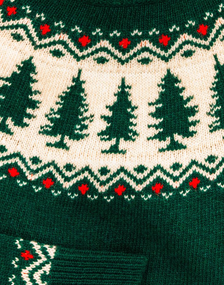 a green and white sweater with trees on it