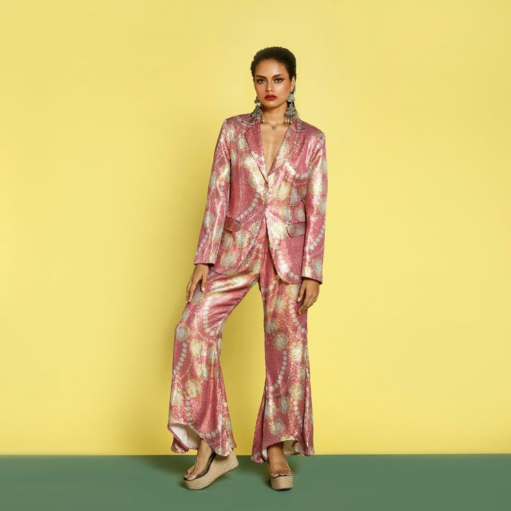 Add some sequins to your festive and party events this season with Katyani Pant Suit set. The flattering sequin wide leg pants are high waisted and complements every body type. The pant suit is trans seasonal . The front hook full sequin blazer has pockets. The model is wearing size S. 🌸 〰️〰️〰️ 🌸 〰️〰️〰️ 🌸 Care and Composition100% Sequin.Dry clean/Hand wash in cold water. Mild liquid detergent only. Do not soak or wring. Designed & Made in India. Glamorous Wide Leg Pants For Summer Evenings, Glamorous Summer Evening Wide Leg Pants, Glamorous Evening Wide Leg Pants For Summer, Summer Wide-leg Pantsuit For Party, Glamorous Wide Leg Pants For Spring Party, Summer Glamorous Formal Sets, Glamorous Formal Summer Sets, Chic Festive Evening Pant Set, Chic Evening Festive Pant Set