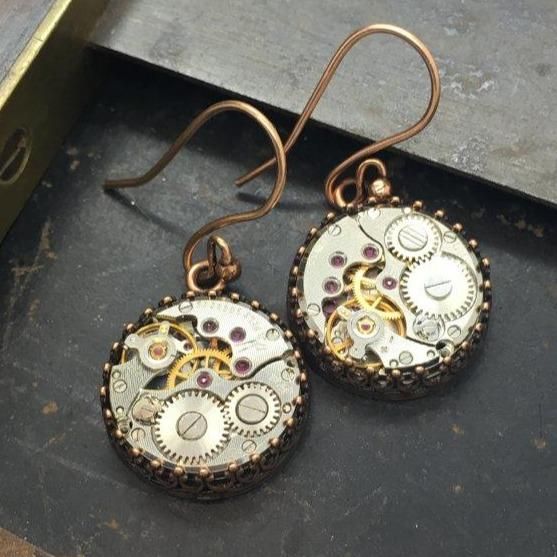 Jane, Vintage Watch Movement Earrings #upcycle #localartist #gothicstyle #gothicfashion #fantasy #vintagejewelry #artjewelry #victorianjewelry #boho #statementjewelry Classic Antique Gold Metal Jewelry, Nickel-free Antique Gold Metal Jewelry, Gold Round Soldered Earrings, Gold Round Earrings With Soldered Details, Formal Bronze Round Earrings, Handmade Gold Stainless Steel Earrings, Handmade Stainless Steel Gold Earrings, Antique Gold Metal Jewelry, Timeless Metal Earrings For Pierced Ears