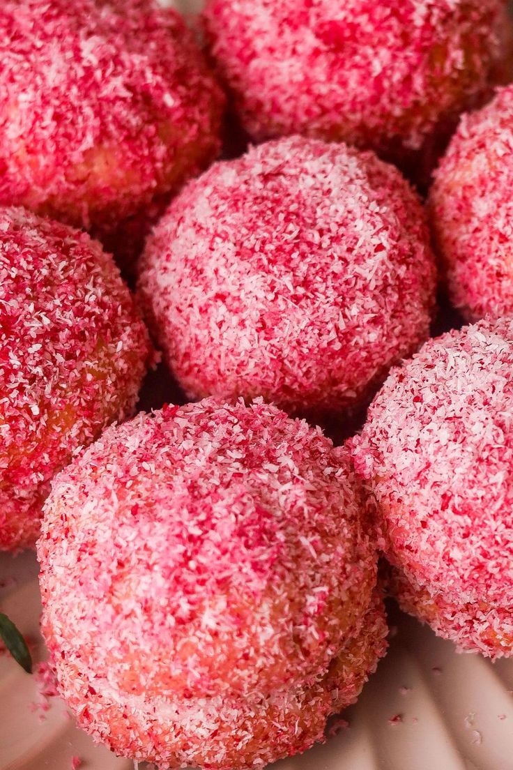 some sugared pastries are sitting on a plate with sprinkles around them