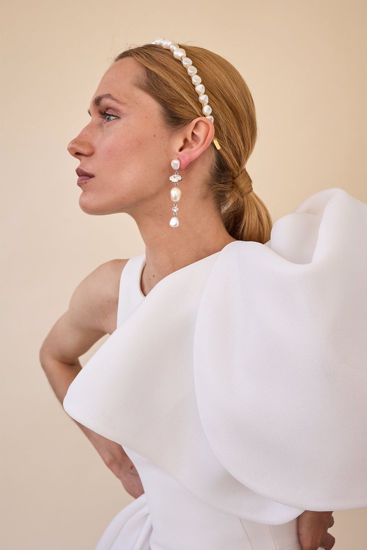 Indulge in opulent elegance with our Aria Pearl and Crystal Earrings. These elevated drop earrings feature organic shaped pearls and multi-shaped Swarovski crystals, adding a touch of artful sophistication to any outfit. Elevate your style and make a statement with these luxe earrings. Made in NYC. Pearl Chandelier Earrings For Party, Pearl Charm Chandelier Earrings For Party, Pearl White Pearl Earrings For Evening, Pearl White Chandelier Earrings With Pearl Drop For Parties, Chic Pearl Drop Chandelier Earrings For Weddings, Chic Pearl Embellished Earrings For Wedding, Chic Pearl Embellished Earrings For Evening, White Pearl Charm Chandelier Earrings For Party, Glamorous White Pearl Chandelier Earrings