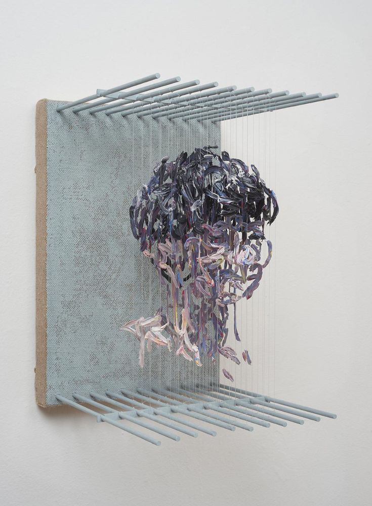 a sculpture made out of metal rods on a wall