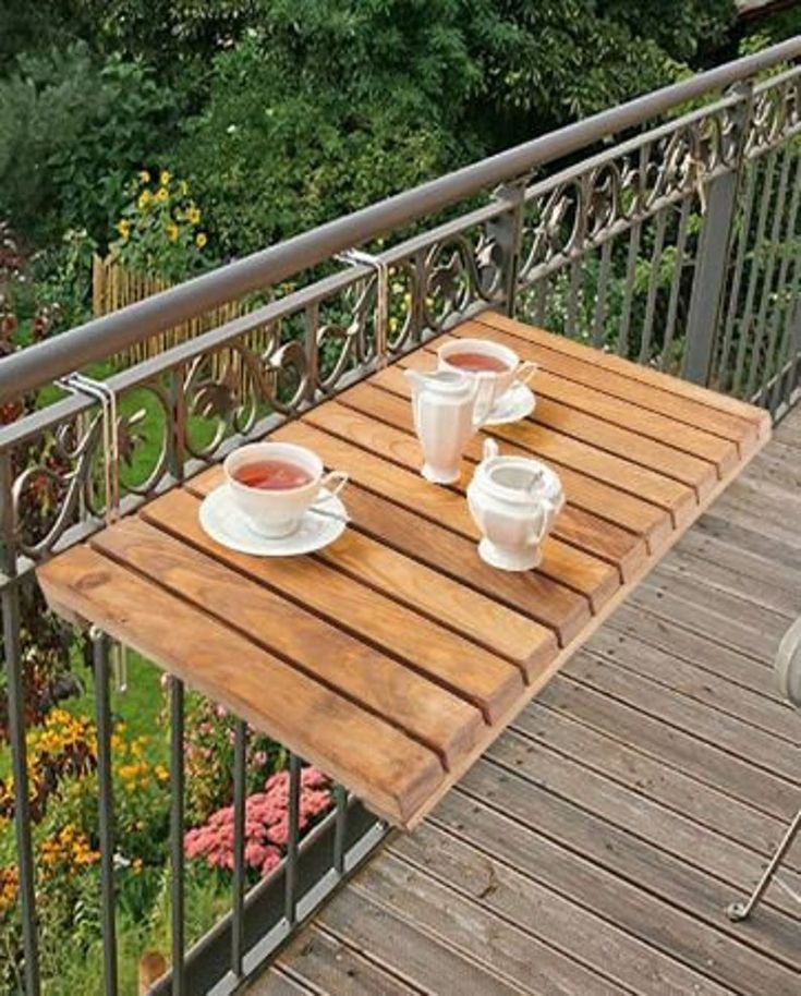 two cups of tea sit on a wooden table